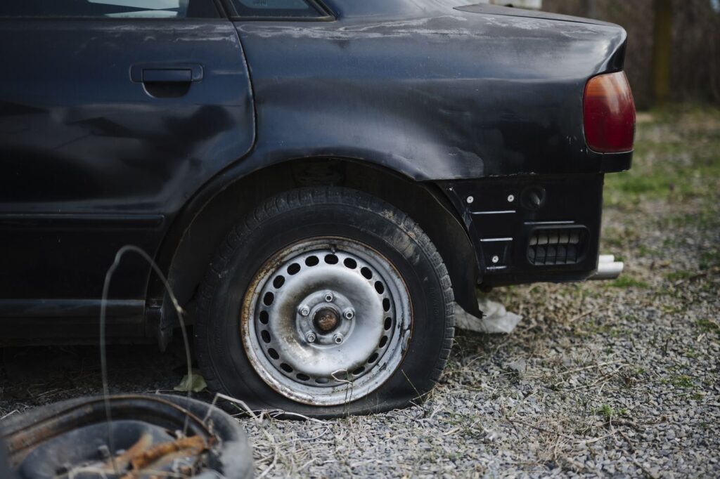 Car with a flat rear tire