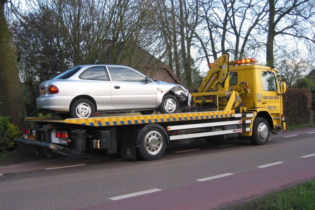 Flatbed tow truck carrying a car