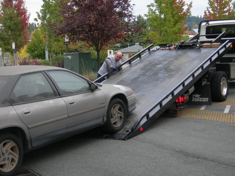 Sedan being loaded onto a flatbed truck